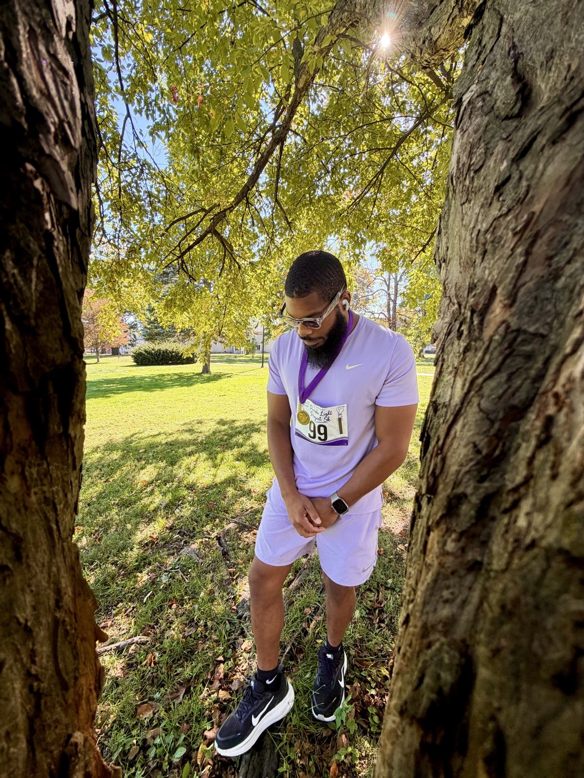 Harrison wearing bib 99 and his medal after the Purple Light Project 5K