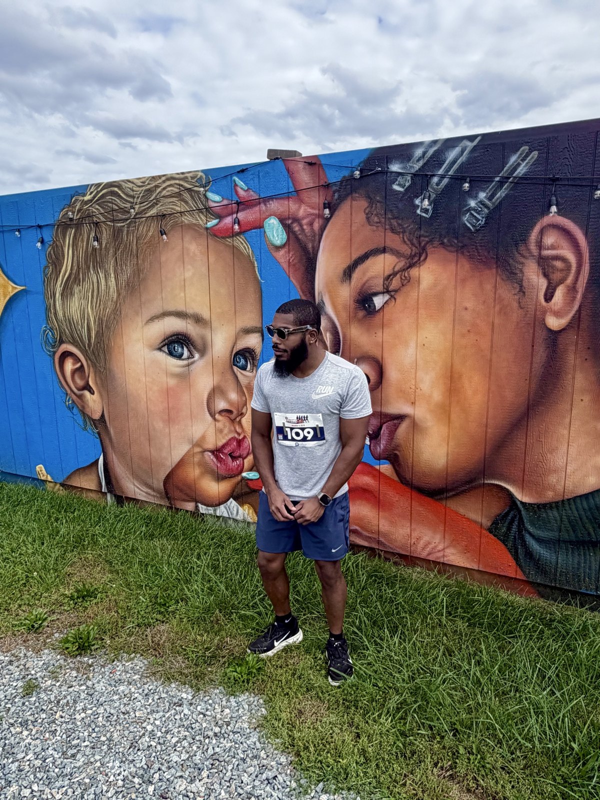 Harrison standing in front of a colorful mural after the 2026 Sheriff's Shuffle