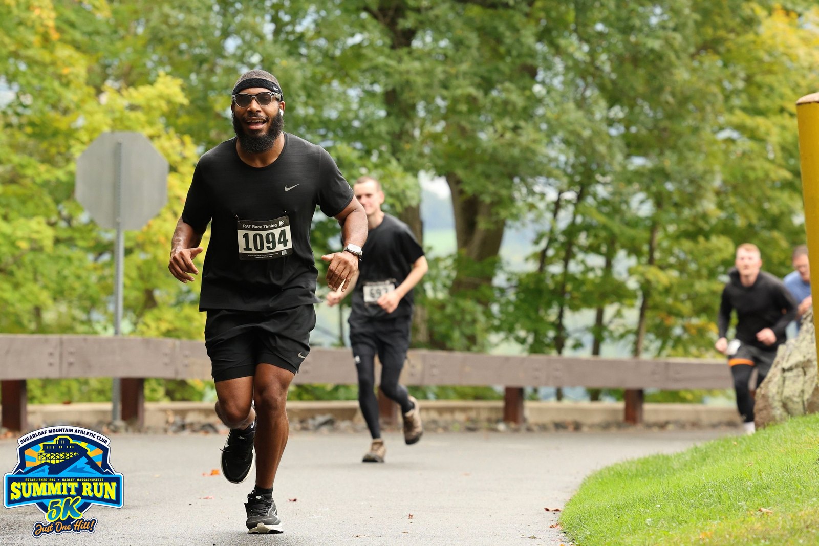 Harrison running uphill in bib 1094 during the Summit Run 5K